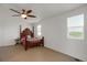 Bright bedroom with a wooden four-poster bed, ceiling fan, and natural light from two windows at 18553 County Road 5, Berthoud, CO 80513