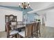 Open-concept dining room features a large table, seating for eight, and an elegant chandelier at 18553 County Road 5, Berthoud, CO 80513