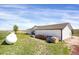 Back of house features white siding with a large yard and storage tanks on the property at 18553 County Road 5, Berthoud, CO 80513