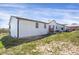 The back of this home features an expansive yard and a back deck area at 18553 County Road 5, Berthoud, CO 80513