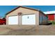 Two-car garage with beige siding and white doors provides ample parking and storage space at 18553 County Road 5, Berthoud, CO 80513
