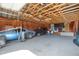 Spacious garage interior with high ceilings, exposed wooden beams, and ample space for multiple vehicles at 18553 County Road 5, Berthoud, CO 80513