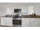 Updated kitchen features white cabinets, stainless appliances, and granite countertops at 18553 County Road 5, Berthoud, CO 80513