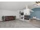 Open-concept living room features hardwood floors, a fireplace, and custom built-ins for a modern and cozy space at 18553 County Road 5, Berthoud, CO 80513