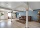 Living room featuring wood floors, columns, and a leather sofa at 18553 County Road 5, Berthoud, CO 80513