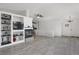 Bright living room features a fireplace, built-in shelving, and modern gray wood flooring at 18553 County Road 5, Berthoud, CO 80513