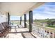 Inviting porch with wrought iron furniture offers peaceful views of green lawns and distant landscapes at 18553 County Road 5, Berthoud, CO 80513