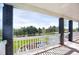 Spacious porch offers scenic views of the lush green lawn and distant trees, perfect for relaxation at 18553 County Road 5, Berthoud, CO 80513