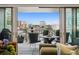 Balcony with views of the city and patio furniture at 155 Steele St # 418, Denver, CO 80206
