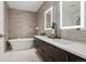 A luxurious bathroom with double sinks, soaker tub, and modern tile at 155 Steele St # 418, Denver, CO 80206