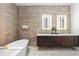The bathroom features a soaking tub, double vanity, and luxury tile at 155 Steele St # 418, Denver, CO 80206