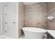 Bright bathroom features a soaking tub, with luxury tile and modern finishes at 155 Steele St # 418, Denver, CO 80206
