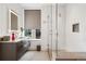 Bathroom featuring modern fixtures, an enclosed glass shower, and ample counter space at 155 Steele St # 418, Denver, CO 80206