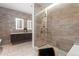 This bathroom features a glass shower and double vanity with luxury tile at 155 Steele St # 418, Denver, CO 80206