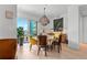 Bright dining room featuring a modern chandelier, with access to a view of the balcony at 155 Steele St # 418, Denver, CO 80206