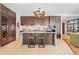Modern kitchen with an island, wine cooler, stainless steel appliances, and dark wood cabinets for a sleek design at 155 Steele St # 418, Denver, CO 80206