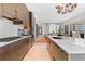Modern kitchen features dark wood cabinets, stone countertops, stainless steel appliances, and hardwood flooring at 155 Steele St # 418, Denver, CO 80206