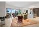 An open living room boasts an area rug, sophisticated decor, and access to the balcony at 155 Steele St # 418, Denver, CO 80206