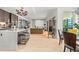 Bright, open-concept living room featuring modern lighting, hardwood floors, and large windows offering city views at 155 Steele St # 418, Denver, CO 80206