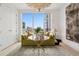 Cozy living room with large window, hardwood floors, and a comfortable couch at 155 Steele St # 418, Denver, CO 80206