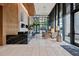 Grand lobby entrance with a black marble reception desk and floor to ceiling windows at 155 Steele St # 418, Denver, CO 80206