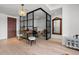 Bright office space with a glass enclosure, chandelier, hardwood floors, and refined decor for a modern look at 155 Steele St # 418, Denver, CO 80206