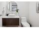 Stylish powder room with modern vanity, round mirror, and contemporary fixtures at 155 Steele St # 418, Denver, CO 80206