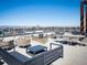 Expansive rooftop patio with city views, complete with stylish seating and landscaping at 155 Steele St # 418, Denver, CO 80206