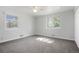 Bright bedroom with two windows, neutral walls, and ceiling fan at 5455 Dudley Ct, Arvada, CO 80002