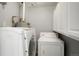 Functional laundry area equipped with washer, dryer, and convenient storage cabinets at 5455 Dudley Ct, Arvada, CO 80002