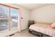 Cozy bedroom featuring a large window with blinds and a comfortable bed frame at 16505 E Arkansas Ave, Aurora, CO 80017