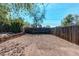 Gravel-filled backyard with wood fence and mature trees offers outdoor living space at 8540 Corona St, Denver, CO 80229