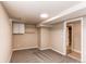 Another view of the carpeted basement room with closet, shelves and view to tiled room at 8540 Corona St, Denver, CO 80229