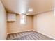 Finished basement with neutral walls, carpet, and a white storage cabinet at 8540 Corona St, Denver, CO 80229