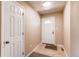 A clean entryway featuring a white front door, neutral tile flooring, and fresh paint at 8540 Corona St, Denver, CO 80229