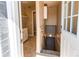 Entryway with ceramic tile, coat closet and staircase to basement, and utility room beyond at 8540 Corona St, Denver, CO 80229