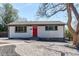 Charming single-story home featuring a red door and low maintenance landscaping with gravel and rock at 8540 Corona St, Denver, CO 80229