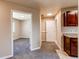 Hallway leads to the rooms in the house with neutral walls, new carpet, and natural light at 8540 Corona St, Denver, CO 80229