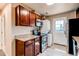 Modern kitchen equipped with granite countertops, stainless appliances, and convenient washer/dryer units at 8540 Corona St, Denver, CO 80229