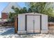 Backyard storage shed with double doors sits on a concrete pad behind a brick home at 8540 Corona St, Denver, CO 80229