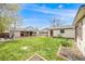 Spacious backyard with a covered deck, lush lawn, and well-manicured garden beds at 1055 Quartz St, Golden, CO 80401