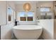 Bright bathroom showcasing a freestanding tub and a glass-enclosed shower at 1055 Quartz St, Golden, CO 80401