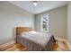 A simple bedroom with hardwood floors, neutral walls, and a comfortable-looking bed at 1055 Quartz St, Golden, CO 80401