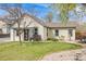 Lovely home with a manicured lawn, inviting entrance, and charming curb appeal at 1055 Quartz St, Golden, CO 80401