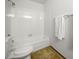 Bathroom with a combined tub and shower featuring tiled walls, a toilet, and a towel rack on the wall at 3407 S Ammons St # 20-1, Lakewood, CO 80227