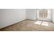 Carpeted bedroom featuring a large window that lets in natural light at 3407 S Ammons St # 20-1, Lakewood, CO 80227
