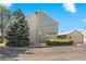 Charming end-unit townhome with a brick facade and mature evergreen tree at 3407 S Ammons St # 20-1, Lakewood, CO 80227