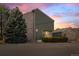 Inviting exterior of the home featuring a large evergreen tree and charming brick and siding at 3407 S Ammons St # 20-1, Lakewood, CO 80227