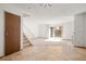 Bright living room featuring tile entry, sliding glass doors and stairs to upper level at 3407 S Ammons St # 20-1, Lakewood, CO 80227