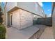 View of the side yard with an air conditioning unit, rockscaping and brick exterior at 3407 S Ammons St # 20-1, Lakewood, CO 80227